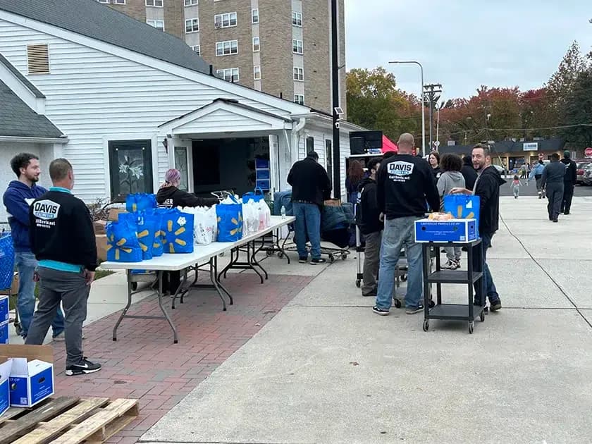 Davis Heating and Air volunteers preparing donation bags at Cherry Hill outreach program
