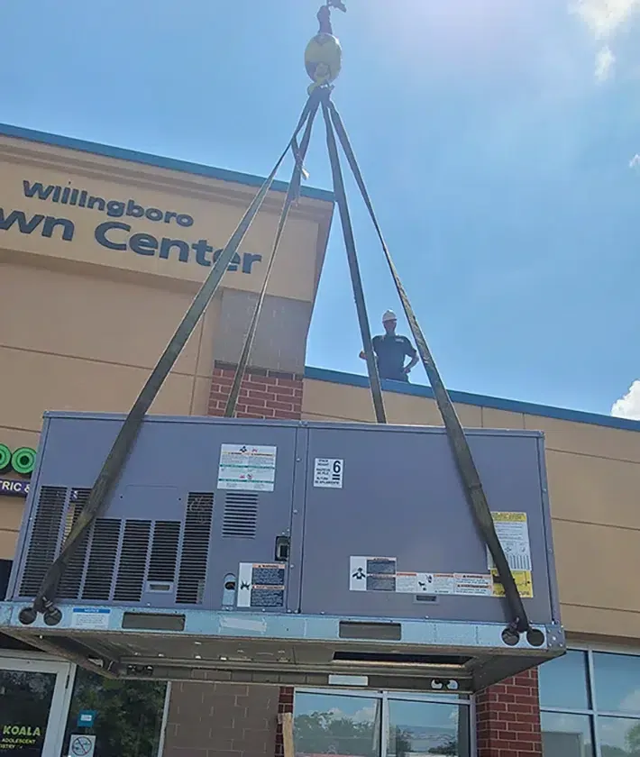 Davis Heating and Air crane lift placing HVAC equipment at a Cherry Hill commercial building