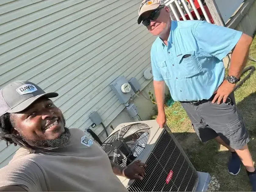 Technician servicing an outdoor AC condenser for Davis Heating and Air in Cherry Hill