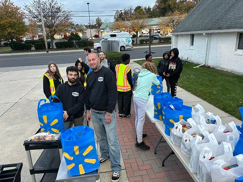 Davis Heating and Air team distributing food supplies at Cherry Hill community event