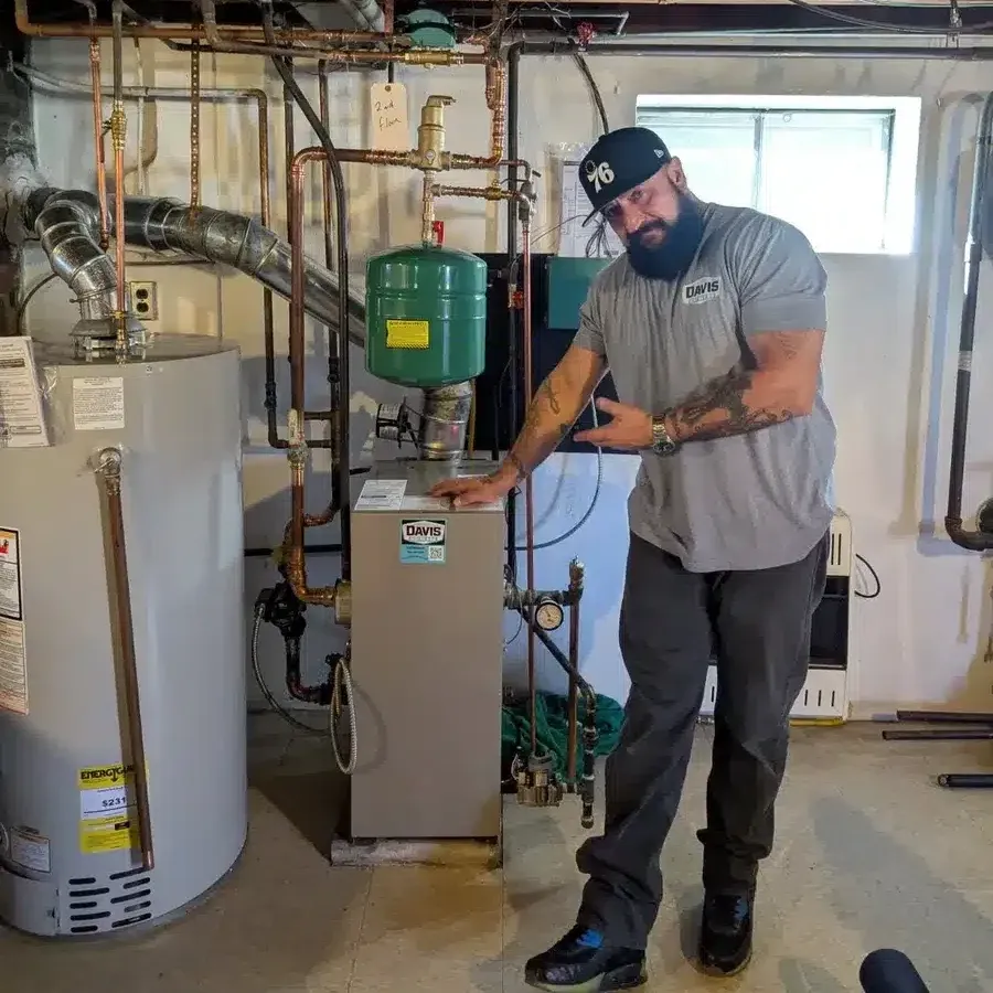 Technician standing in front of boiler installation in Cherry Hill, NJ.