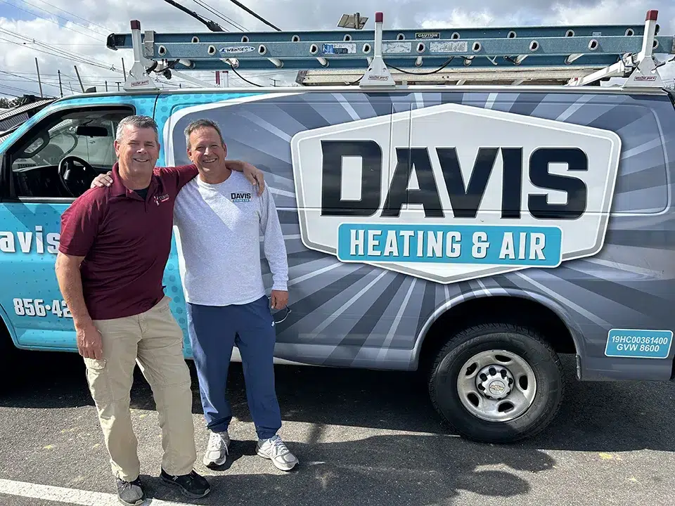 two employees in front of Davis Heating and Air truck
